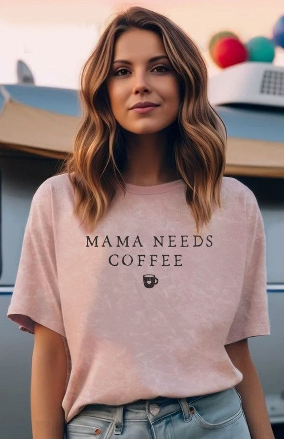 Woman wearing a muted pink t-shirt with 'Mama Needs Coffee' text and a coffee cup icon.