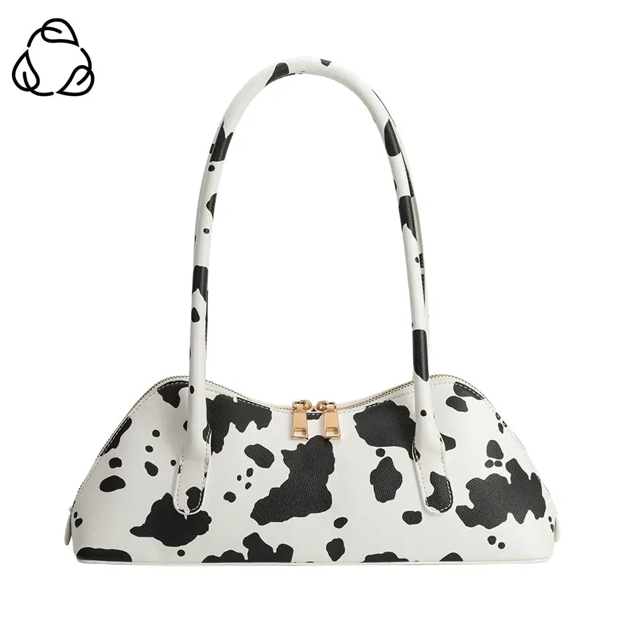 Handbag with black and white cow print pattern on a white background