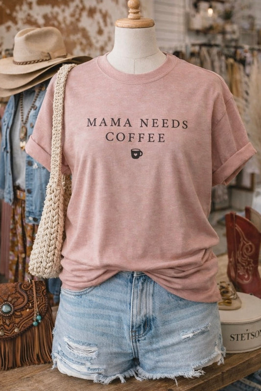 Muted Pink t-shirt with 'Mama Needs Coffee' text on a mannequin in a store setting.