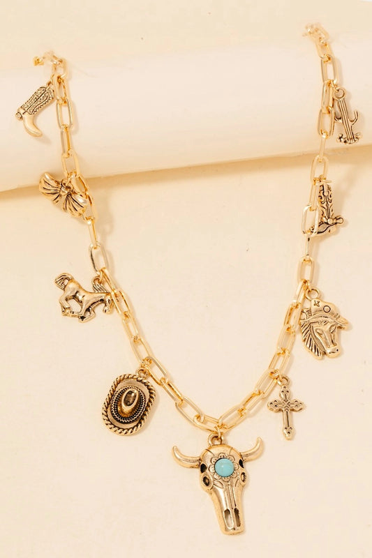 Gold necklace with 9  western charms on a beige background