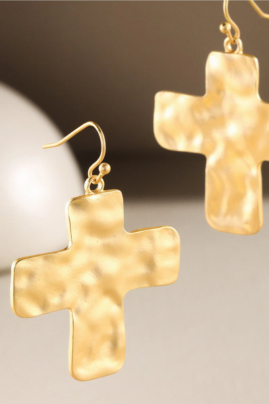 Hammered Gold cross-shaped earrings on a neutral background