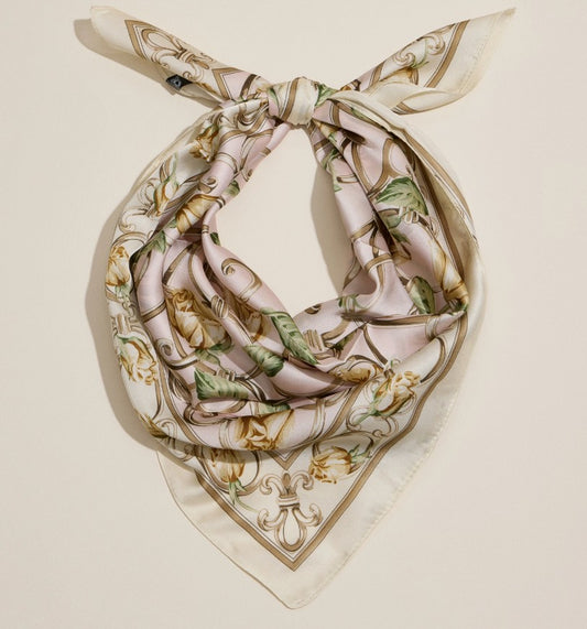 Decorative silky scarf with intricate yellow rose patterns on a beige background